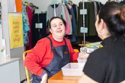 A girl sits in an op shop